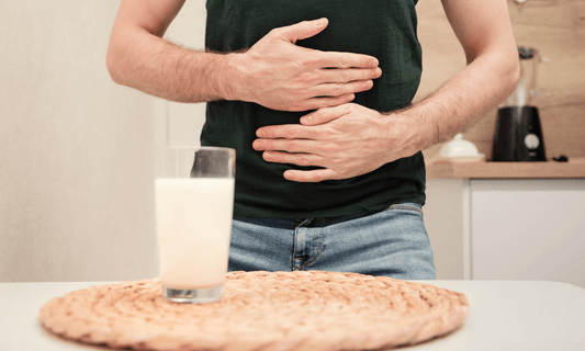 Man holding stomach with milk 