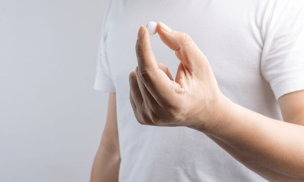 Man holding lactase tablet