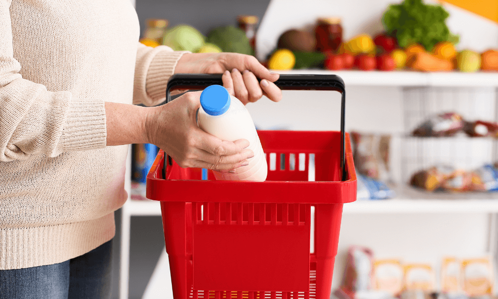 Woman with milk in shipping basket 