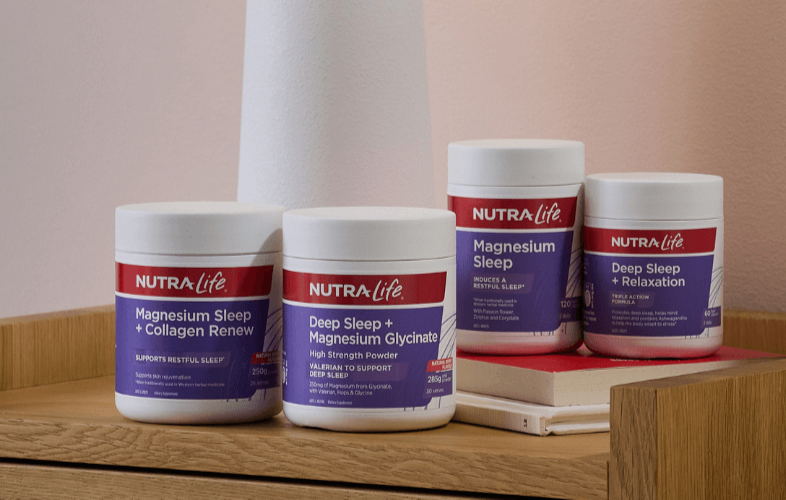 Nutra Life sleep supplement containers on a wooden surface with a neutral background